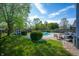 Spacious backyard featuring a well-maintained pool, lush green lawn, and mature trees at 419 Old Glory Dr, Greenfield, IN 46140