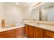 Bathroom featuring a soaking tub with tile surround, vanity with mirror, and modern fixtures at 419 Old Glory Dr, Greenfield, IN 46140