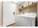 Well-equipped laundry area with a washer, dryer, and overhead shelf for convenient storage at 419 Old Glory Dr, Greenfield, IN 46140