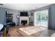 Open living room with a fireplace, modern decor, and access to the outdoor pool area at 419 Old Glory Dr, Greenfield, IN 46140