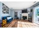 Bright living room with hardwood floors, a fireplace, and sliding glass doors to the patio at 419 Old Glory Dr, Greenfield, IN 46140