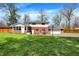 Beautiful backyard with a well-maintained lawn, patio, and partial fencing at 4260 Springwood Trl, Indianapolis, IN 46228
