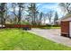 Spacious backyard features a basketball court, patio with outdoor seating, and a well-maintained lawn at 4260 Springwood Trl, Indianapolis, IN 46228