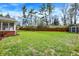 Large, grassy backyard is enclosed by a wood fence, and includes a storage shed at 4260 Springwood Trl, Indianapolis, IN 46228