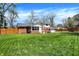 Backyard featuring a two-car garage, a patio and well maintained lawn and partial fencing at 4260 Springwood Trl, Indianapolis, IN 46228