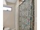 Bathroom featuring shower with decorative curtain, with a small window and white door at 4260 Springwood Trl, Indianapolis, IN 46228