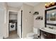 Bathroom featuring dark wood vanity, plants on the walls and doorway to laundry room at 4260 Springwood Trl, Indianapolis, IN 46228