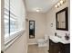 Bright bathroom featuring a dark vanity with a white countertop and a modern mirror at 4260 Springwood Trl, Indianapolis, IN 46228