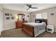 Cozy bedroom featuring a comfortable bed, a ceiling fan, and ample natural light at 4260 Springwood Trl, Indianapolis, IN 46228