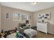 bedroom with neutral walls, window, accent pillows, and a cozy reading chair at 4260 Springwood Trl, Indianapolis, IN 46228