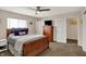 Comfortable bedroom with wood furniture, ceiling fan, and neutral carpet at 4260 Springwood Trl, Indianapolis, IN 46228