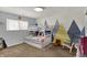 Bedroom with bunk beds, mountain-themed wall decor, window, and chair at 4260 Springwood Trl, Indianapolis, IN 46228