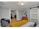 Bedroom with doorway to basement with sliding doors and sitting chair at 4260 Springwood Trl, Indianapolis, IN 46228