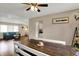 Dining room with hardwood floors, ceiling fan, and access to the living room at 4260 Springwood Trl, Indianapolis, IN 46228