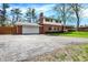Two story brick home with an attached garage and driveway at 4260 Springwood Trl, Indianapolis, IN 46228
