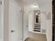 Hallway features neutral paint, tile flooring, and access to stairs and other rooms at 4260 Springwood Trl, Indianapolis, IN 46228