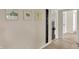 Hallway features neutral paint, tile flooring, artwork, and a height chart at 4260 Springwood Trl, Indianapolis, IN 46228