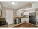 Well-lit kitchen with stainless steel appliances, granite countertops, and white cabinets at 4260 Springwood Trl, Indianapolis, IN 46228