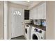 Laundry Room with white washer and dryer, white cabinets and dark wooden countertop at 4260 Springwood Trl, Indianapolis, IN 46228