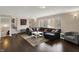 Open living room with a large window, hardwood floors, and comfortable seating at 4260 Springwood Trl, Indianapolis, IN 46228