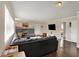 Bright living room with a fireplace, hardwood floors, and a large sectional sofa at 4260 Springwood Trl, Indianapolis, IN 46228