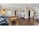 Open concept living area features hardwood floors, a teal sofa, and stairs at 4260 Springwood Trl, Indianapolis, IN 46228
