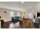 Living room with hardwood flooring, a large window, and a cozy teal sofa at 4260 Springwood Trl, Indianapolis, IN 46228