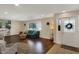 Bright living room with hardwood floors, a teal sofa, and decorative shelving at 4260 Springwood Trl, Indianapolis, IN 46228