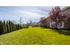 Spacious backyard with green lawn and neatly trimmed hedges, offering plenty of room at 4428 Voyageur Way, Carmel, IN 46074