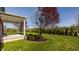 Landscaped backyard with a covered porch and well-maintained lawn at 4428 Voyageur Way, Carmel, IN 46074