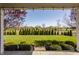 Inviting backyard view with lush green lawn, well-manicured hedges, and open sky at 4428 Voyageur Way, Carmel, IN 46074