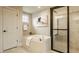 Relaxing bathroom features a soaking tub with tile surround and a separate glass shower at 4428 Voyageur Way, Carmel, IN 46074