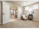 Bedroom featuring a reading nook, a view to the main bathroom, and neutral decor at 4428 Voyageur Way, Carmel, IN 46074