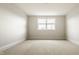 Carpeted bedroom featuring a single window and neutral-colored walls at 4428 Voyageur Way, Carmel, IN 46074