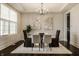 Bright dining room featuring a glass table set, area rug, and modern art on the walls at 4428 Voyageur Way, Carmel, IN 46074