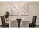 Dining room featuring a glass top table, six chairs, wainscoting, and modern art at 4428 Voyageur Way, Carmel, IN 46074