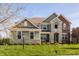Charming two-story home with a combination of siding, brick, and stone accents at 4428 Voyageur Way, Carmel, IN 46074