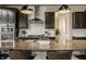 A kitchen with dark cabinets, stainless steel appliances, granite countertops, and bar stool seating at the island at 4428 Voyageur Way, Carmel, IN 46074