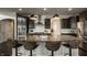 A modern kitchen with dark cabinets, stainless steel appliances, granite countertops, and island seating at 4428 Voyageur Way, Carmel, IN 46074