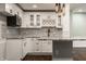 Kitchenette area features white cabinets, granite counters and stainless appliances, and is accented by pendant lights at 4428 Voyageur Way, Carmel, IN 46074