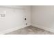 Clean, simple laundry room with tile flooring and wire shelving for ample storage at 4428 Voyageur Way, Carmel, IN 46074