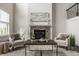 Cozy living room with a stone fireplace, stylish decor, and plenty of natural light at 4428 Voyageur Way, Carmel, IN 46074