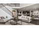 Bright and airy living room with a fireplace, staircase, and open floor plan at 4428 Voyageur Way, Carmel, IN 46074