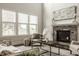 Bright and airy living room featuring large windows and a beautiful stone fireplace at 4428 Voyageur Way, Carmel, IN 46074