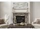 Close-up of living room fireplace with stone surround, hearth, and mantle at 4428 Voyageur Way, Carmel, IN 46074