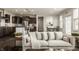 Bright living room with large sofa, eat-in kitchen, and dining area views at 4428 Voyageur Way, Carmel, IN 46074