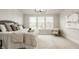 Bright main bedroom featuring a luxurious bed, chair, large windows and neutral decor at 4428 Voyageur Way, Carmel, IN 46074