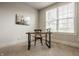 Office space with a window, wood desk, an office chair, carpet and a framed art piece at 4428 Voyageur Way, Carmel, IN 46074