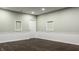 Finished room features modern recessed wall cutouts with white trim and baseboards, a door and wood floors at 4428 Voyageur Way, Carmel, IN 46074