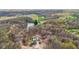 Aerial view of a house on wooded lot with a lake nearby at 4976 W Sims Ln, Monrovia, IN 46157